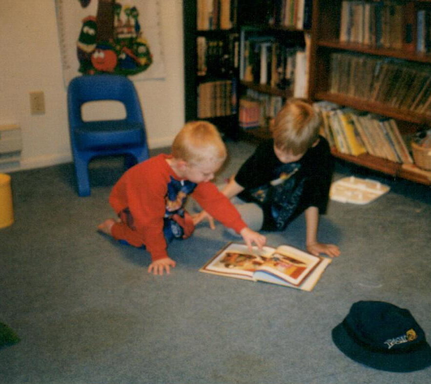 Two of the oys reading quietly in the playroom.