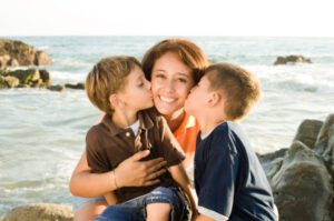 Boys kiss their mother